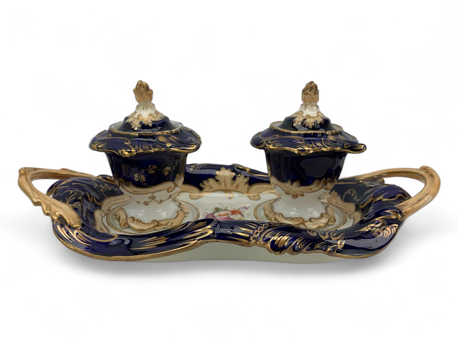 19th century porcelain inkstand, the oblong twin handled base centrally painted with a floral bouquet, flanked by two footed inkwells and covers, with rococo-inspired acanthus moulded borders and handles, pattern no. 2/3339, L26.5cm 