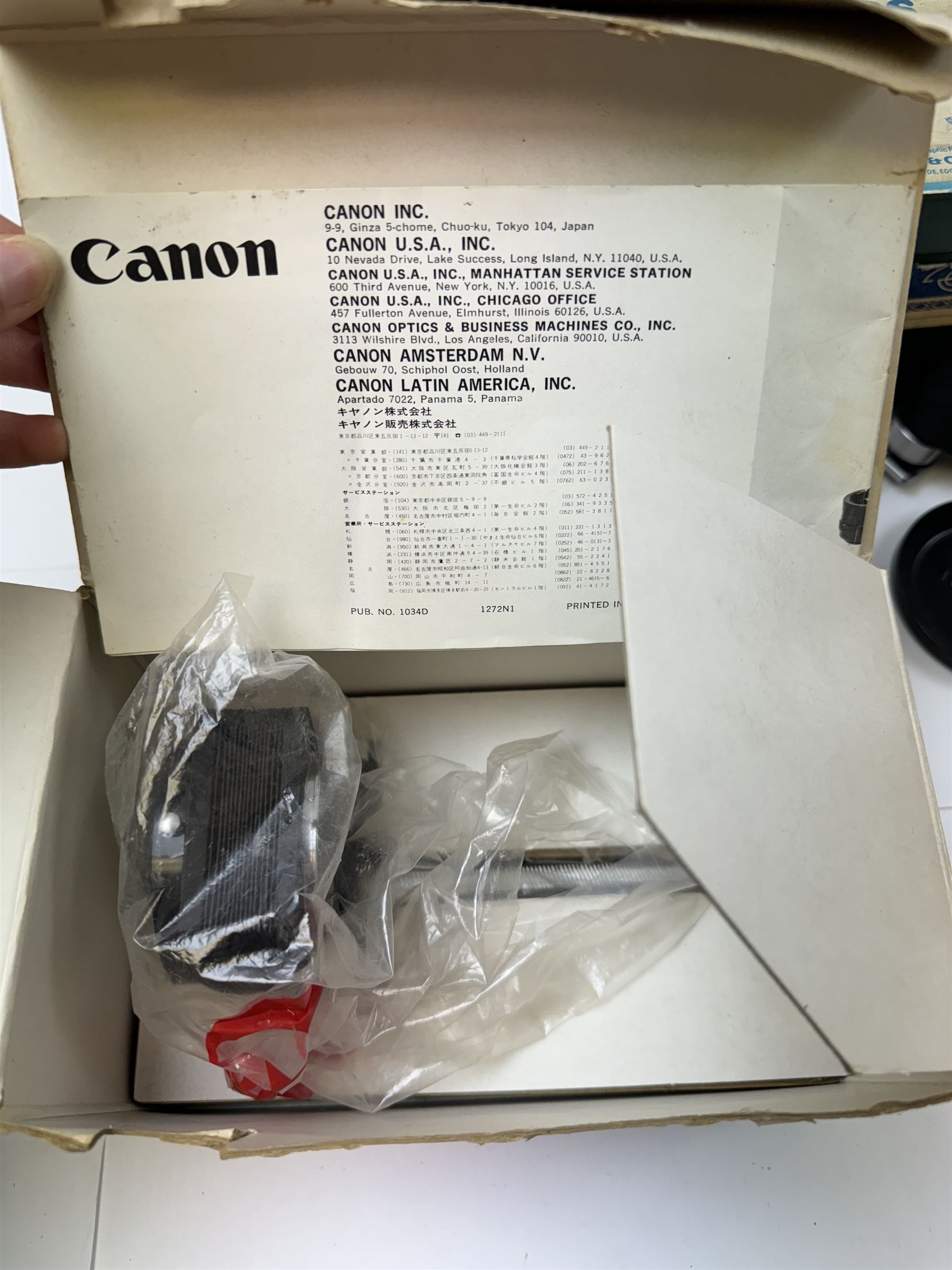 Canon T60 camera body serial no 25230455 together with a collection of Canon camera accessories, including zoom lenses, bellows, etc 