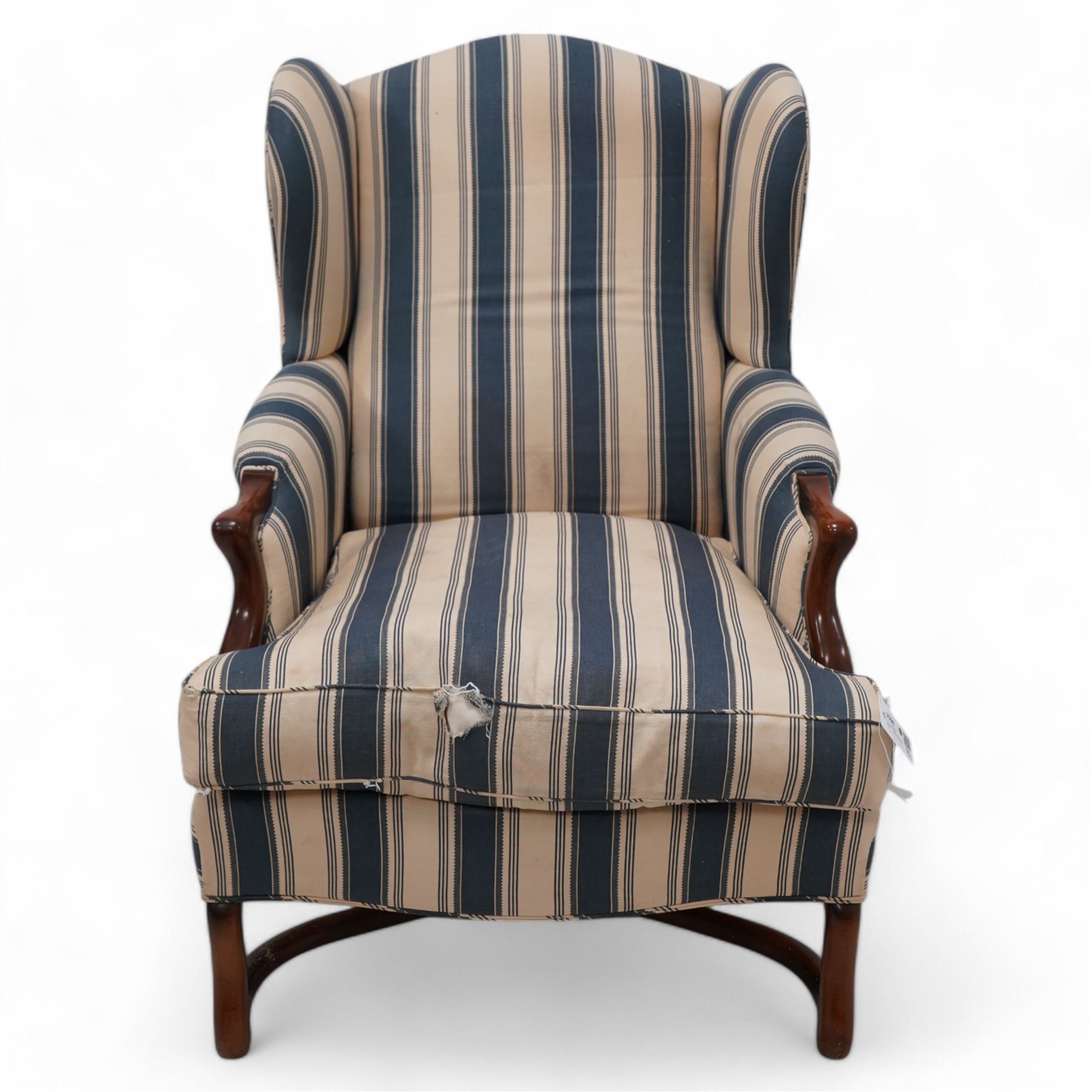 Georgian design wingback armchair, upholstered in blue and cream striped fabric, on shaped supports united by serpentine x-framed stretchers 