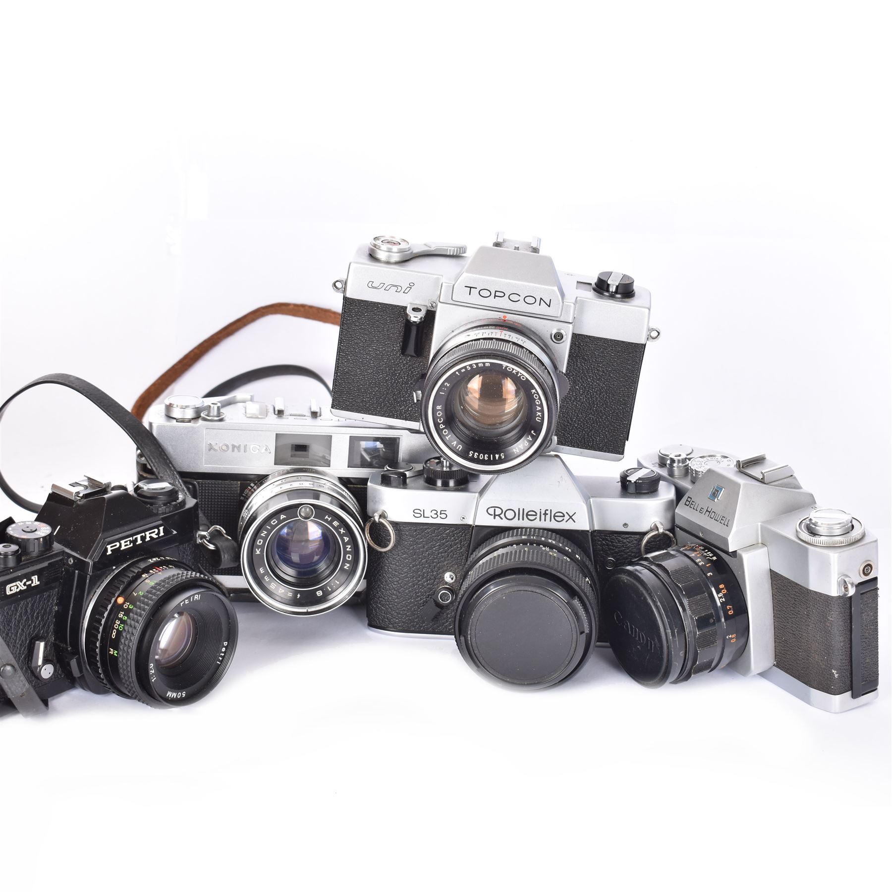 Five SLR cameras, to include Rolleiflex SL35, with a Rollei-HFT Planar 1.8/50 lens serial no. 1246774, Topcon Uni serial no. 5417650, with a Topcor Kogaku UV 1:2 f=53mm lens serial no. 5413035, Bell & Howell Auto35/Reflex Design 237, with a Canon EX 50mm 1:1.8 lens serial no. 92960, Petri GX-1 serial no. 91206945, with a Petri 50mm 1:2.0 lens serial no. 91107428, and a Konica Auto 52 serial no. 1193641, with a Konica Hexanon 1:1.8 f=45mm lens, all in cases 