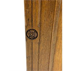 Late Victorian oak twin pedestal desk, chamfered rectangular top over three convex front edge drawers and two panelled cupboards, flanked by carved supports with roundels and diamond motif, on bracketed plinth base