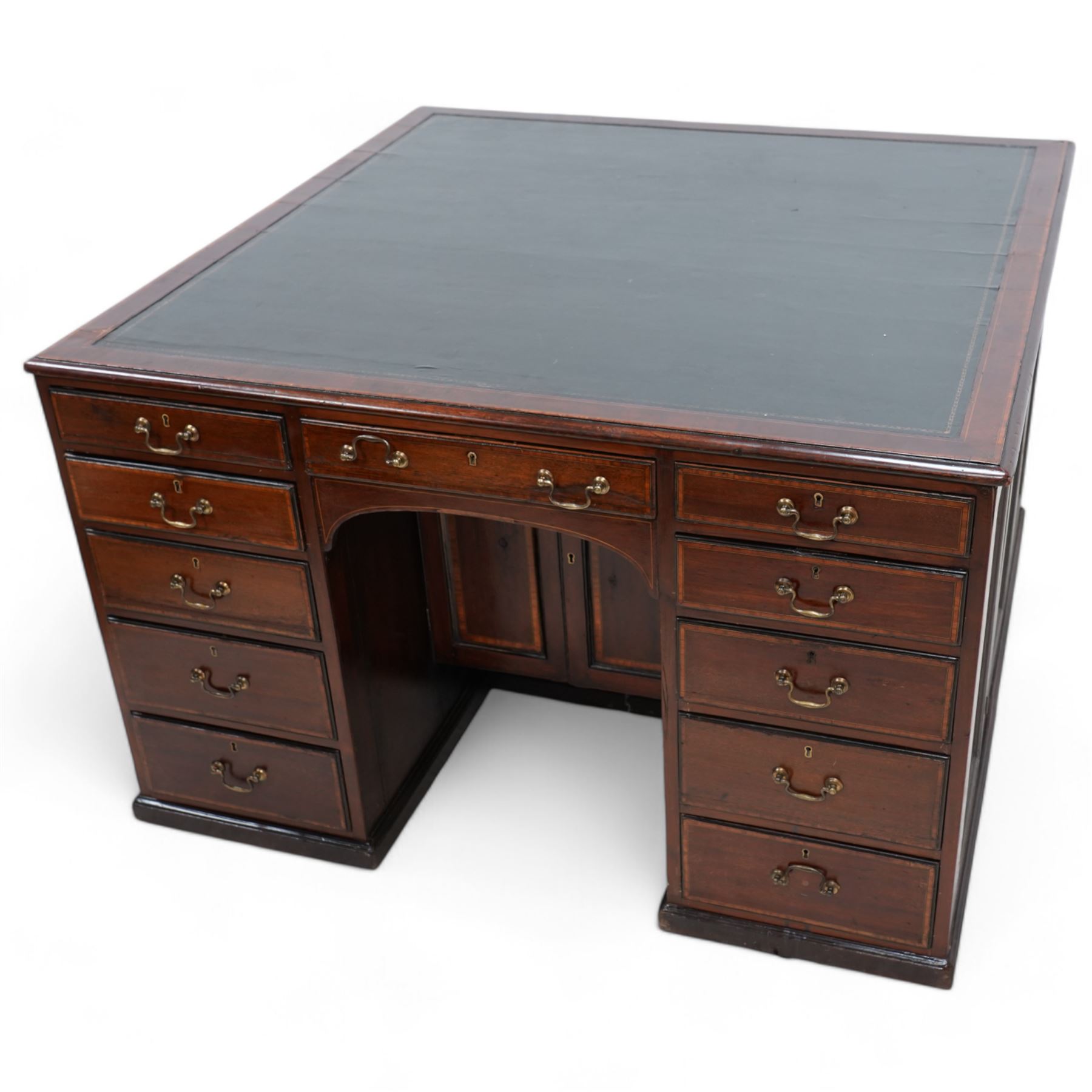 19th century inlaid mahogany kneehole desk, moulded rectangular top with inset leather writing surface and satinwood band, one side fitted with eleven drawers and panelled cupboard, the opposing side with kneehole fitted with eleven drawers and double cupboard, on skirted base with moulded edge 