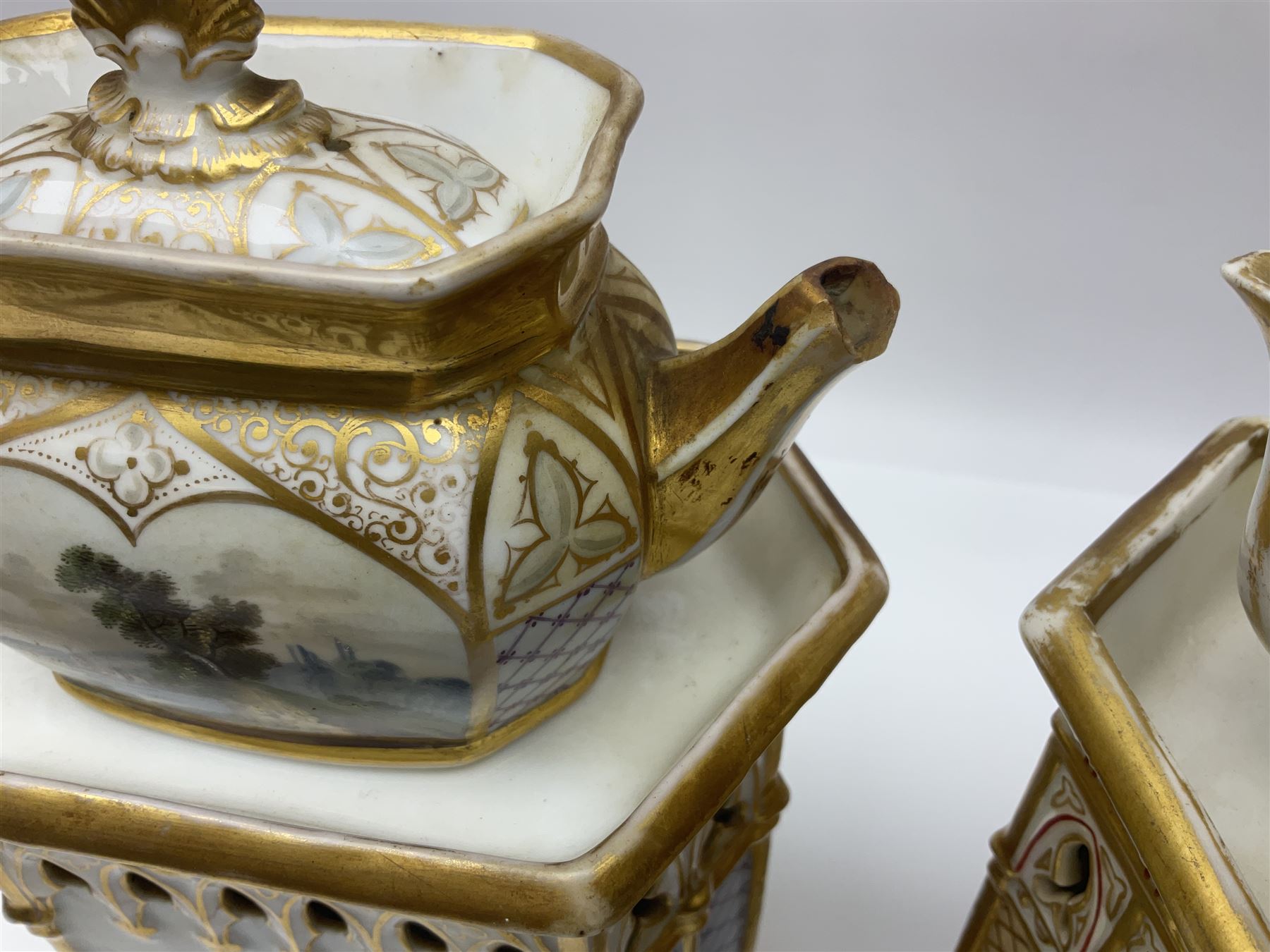 Two 19th century continental teapots and warmers, each teapot upon a hexagonal warming base, the first example painted with landscape scenes, the second with nesting birds in gilt branches, H28cm