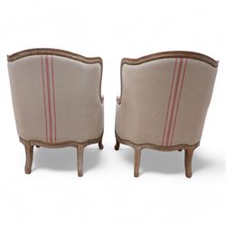 Pair of large hardwood-framed French design armchairs, moulded and shaped frames terminating to cabriole feet, upholstered in pale fabric with pink stripes 