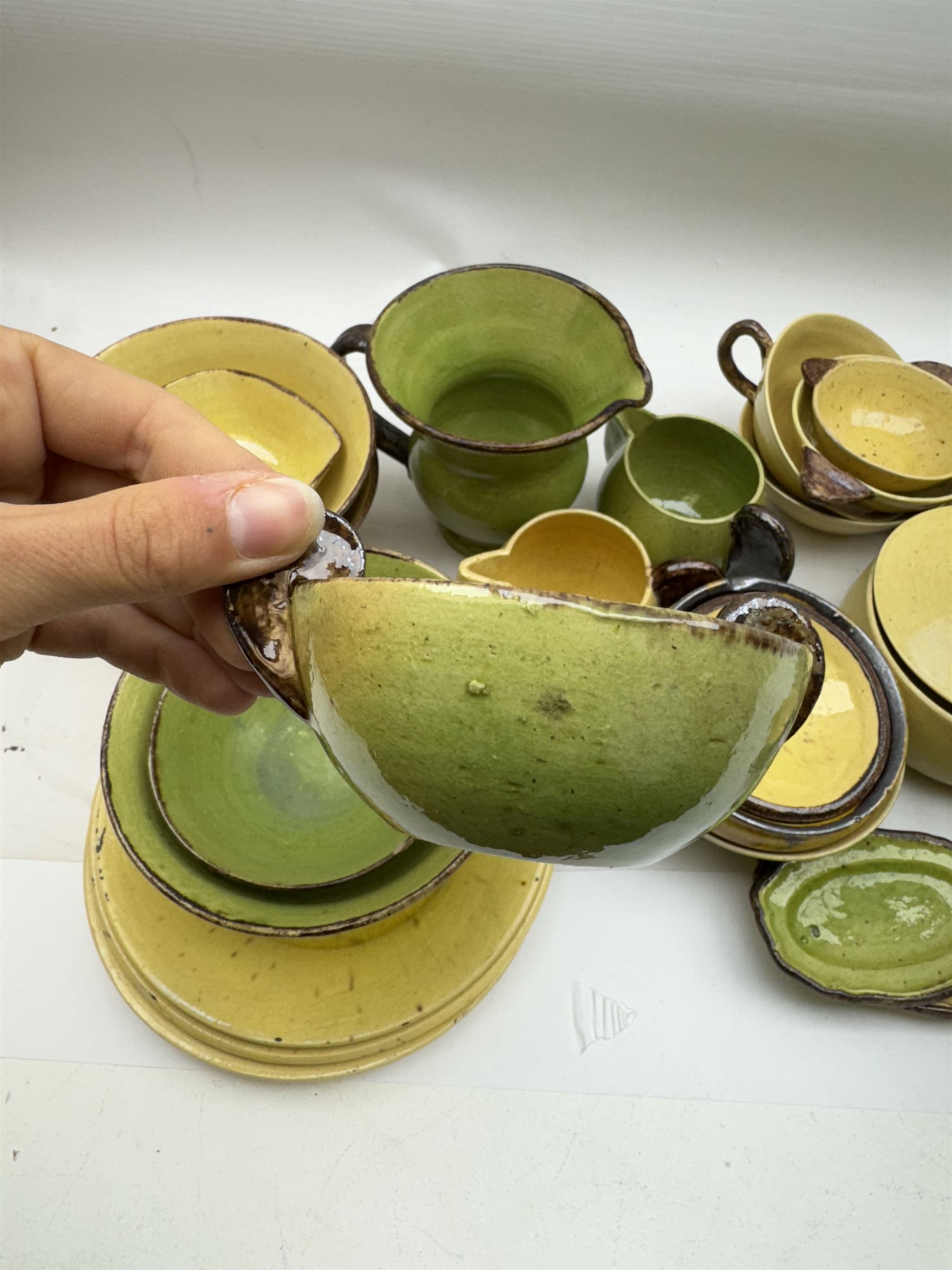 French green and yellow glazed tea and dinner wares by Etienne Noel, including milk jugs, teacups, side plates, bowls etc (43)