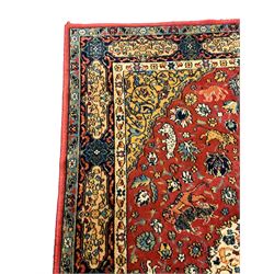 Persian design red ground rug, decorated with plant and animal motifs, the border decorated with floral design panels with guards