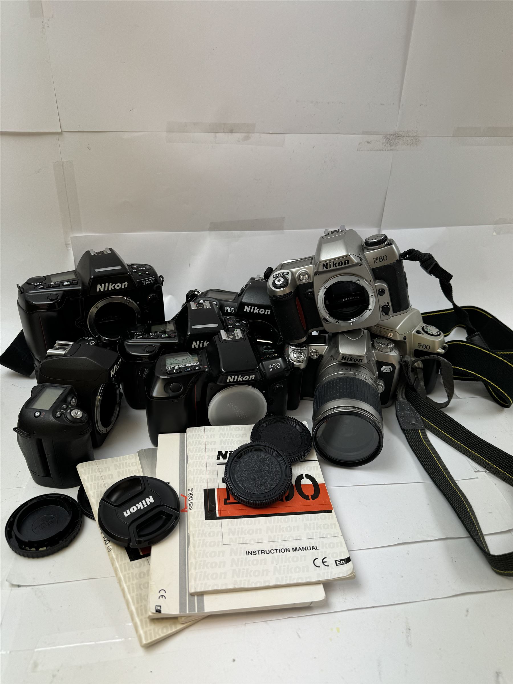 Collection of Nikon cameras, to include F60 serial no. 2574507, boxed, F70 serial no. 2807667, F75 serial no. 2062602, with an AF Nikkor 28-100mm 1:3.5-5.6 G lens serial no. 2166614, two F80 examples serial nos. 2553343 & 2777869, two F90X examples serial nos. 2209737 & 2438888, one boxed and an F100 serial no. 2051550