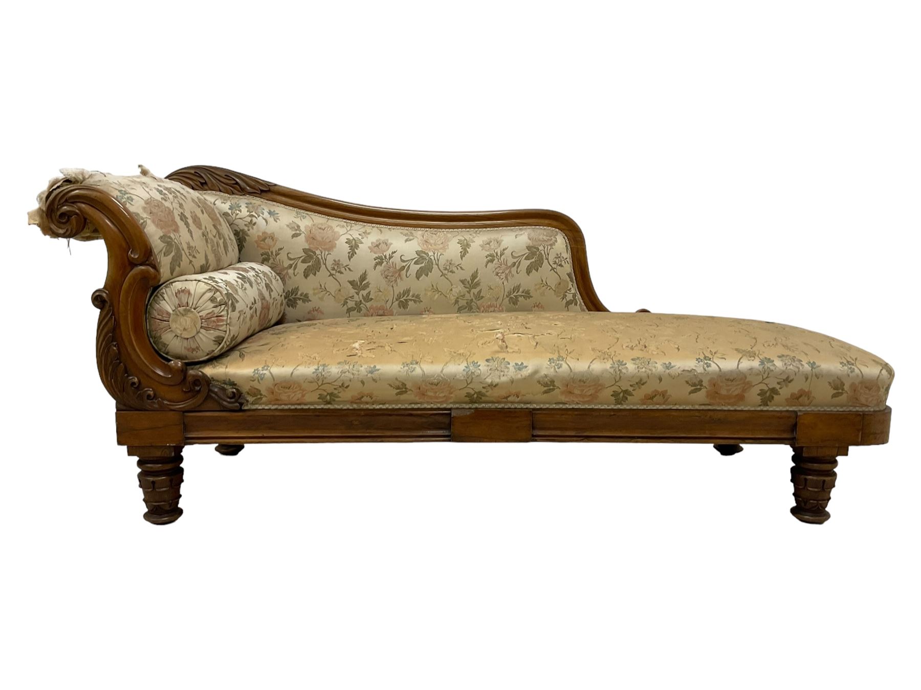 Victorian rosewood chaise longue, rolled back rest and shaped cresting rail carved with curled leaves and scrolls, upholstered in floral pattern fabric with bolster cushion, moulded lower rail with rectangular panel, on turned and lappet carved feet