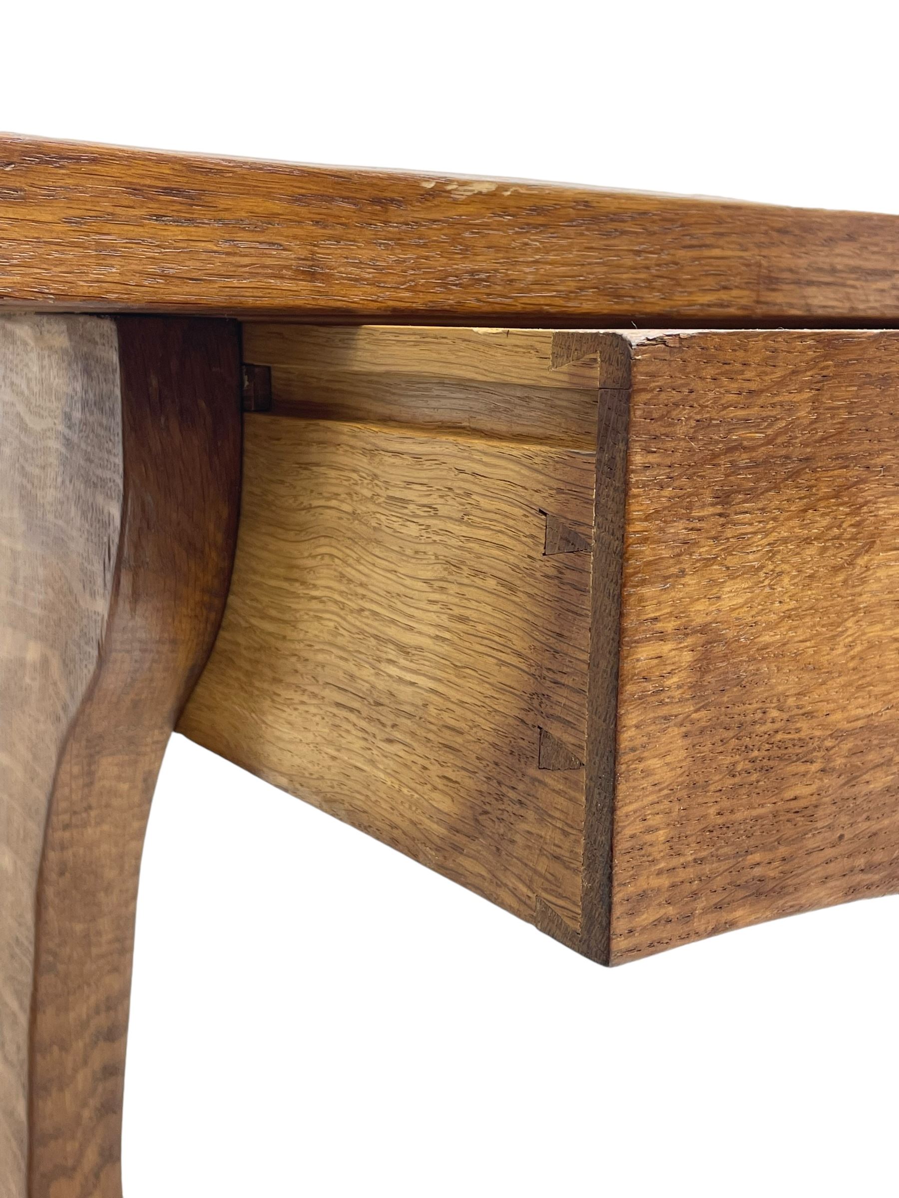 Gnomeman - oak side table, rectangular adzed top over two drawers, on shaped end end supports united by pegged stretcher, carved with gnome signature, by Thomas Whittaker, Littlebeck 