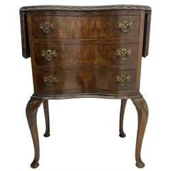 Early to mid-20th century figured walnut lamp table, shaped drop-leaf top with foliate carved edge, fitted with three drawers, on shell carved cabriole supports