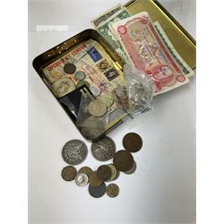 Various coins and banknotes including two Morgan dollars, in a vintage tin