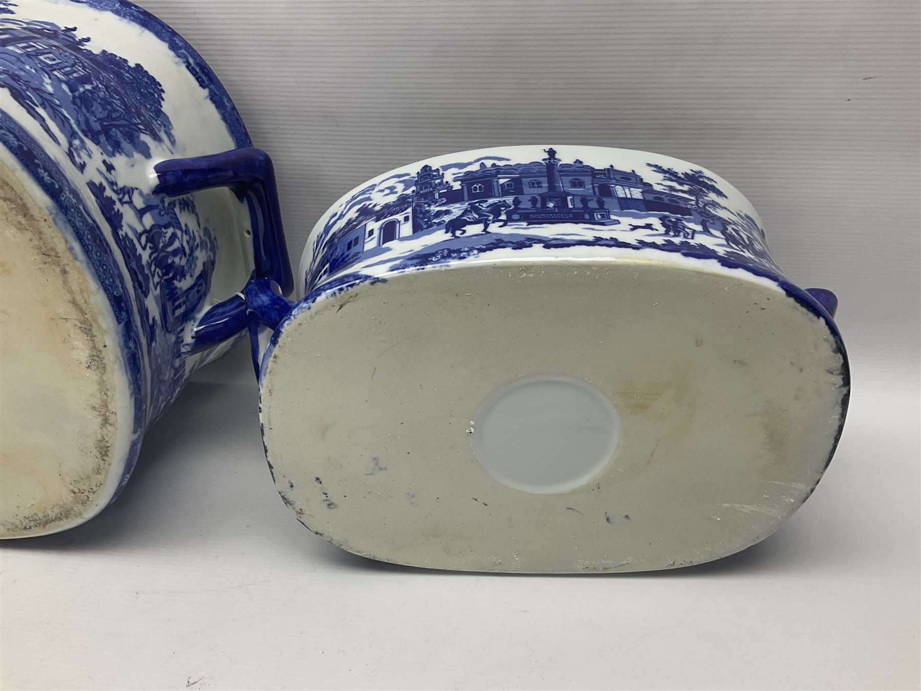 Three Victoria Ware blue and white footbaths, each with twin lug handles and transfer print decorated with city scape, largest H21cm