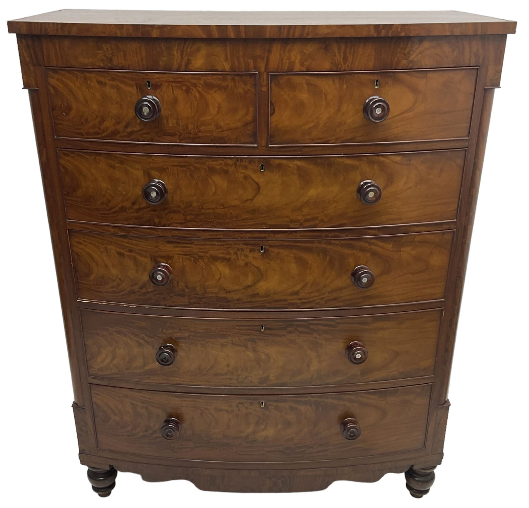 Tall Victorian mahogany bow-front chest, fitted with two short over four long cock-beaded drawers, with turned handles, canted upright corners with quarter columns, shaped apron, on turned feet