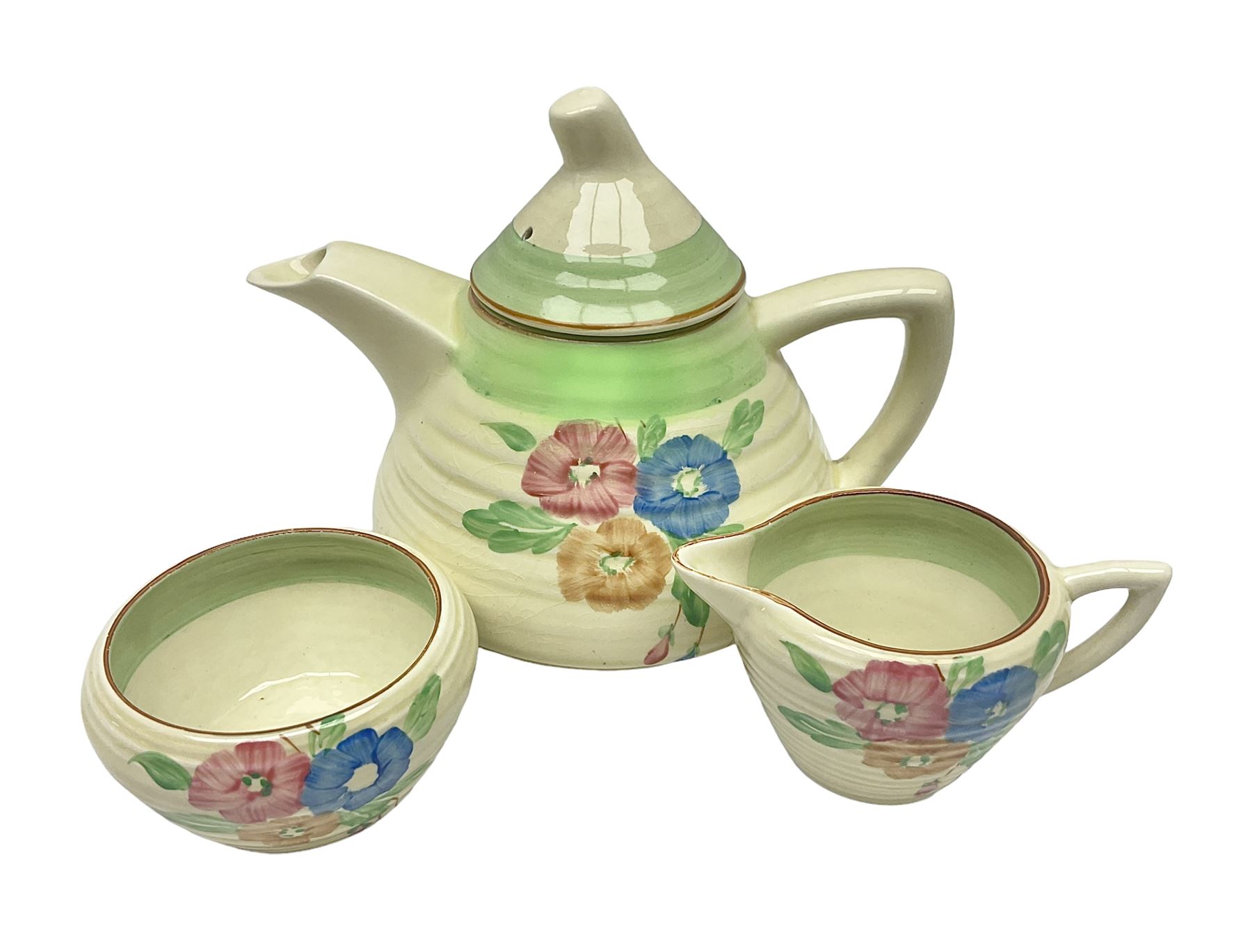 Clarice Cliff for Newport Pottery three piece tea service, in Nosegay pattern, comprising teapot, milk jug and sugar bowl, with printed mark beneath, teapot H12.5cm