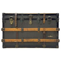 Early 20th century 'McBrine Baggage' steamer trunk, oak frame and black canvas covering, featuring metal hardware and leather straps, fitted with central lock, additional latches, and corner protectors, the interior is lined with floral-patterned paper and includes a removable top tray with makers label 