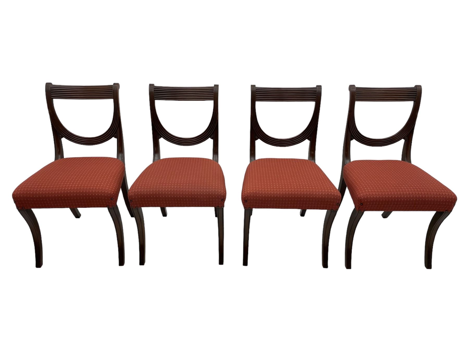 Set of six (4+2) George III design mahogany dining chairs, curved reed moulded bar back over curved and reeded middle rail, upholstered in red fabric with repeating pattern, on moulded sabre supports 