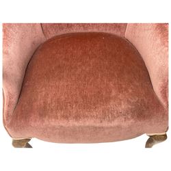 Early 20th century hardwood-framed armchair, high shaped back over shaped arms, upholstered in pink fabric, on cabriole front supports 