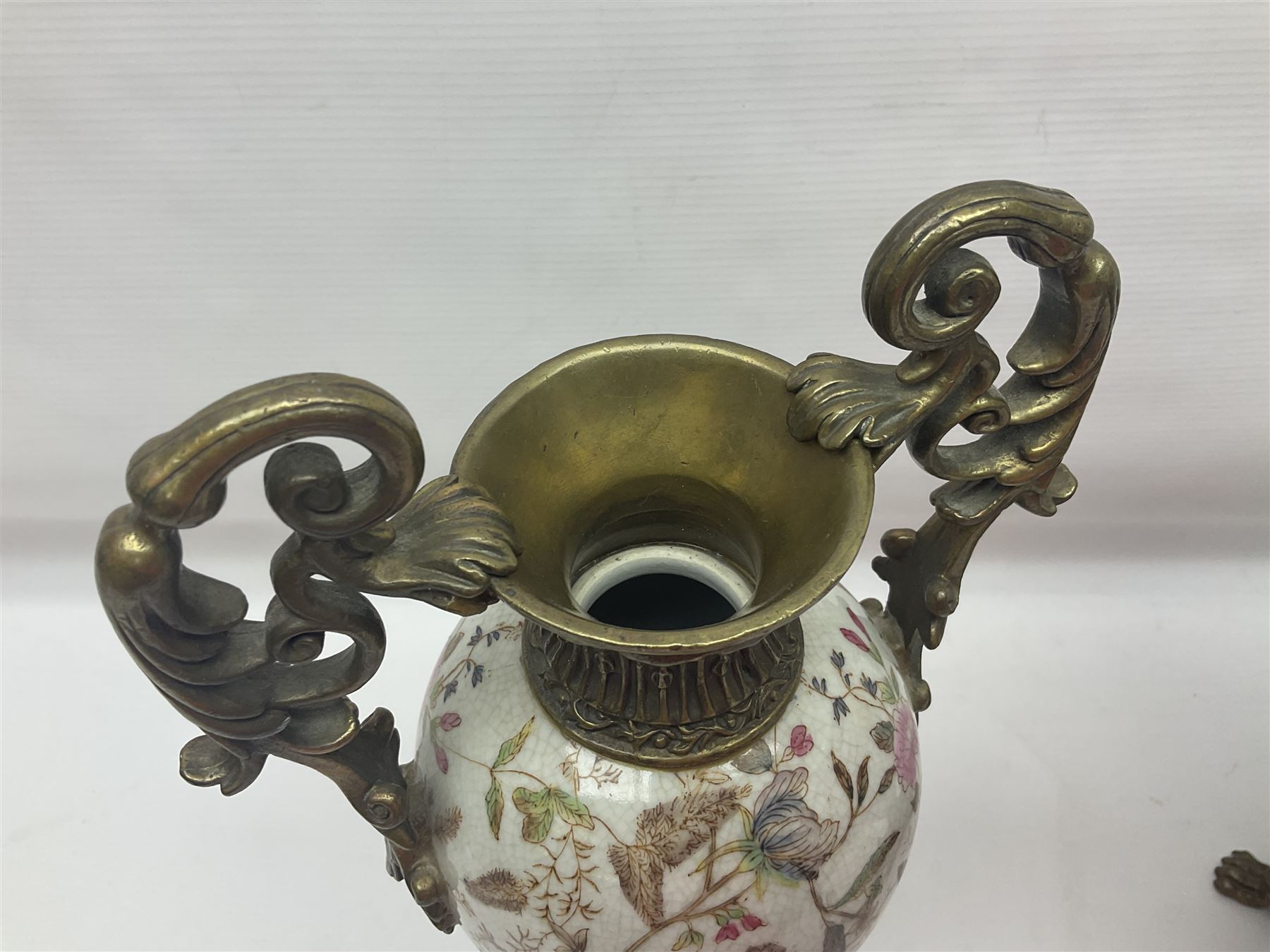 Wong Lee, twin handled ceramic urn with enamelled floral decoration and bronzed metal mounts, upon a square base, marked to base, together with similar twin handled urn with enamelled Cherub decoration, largest H44cm