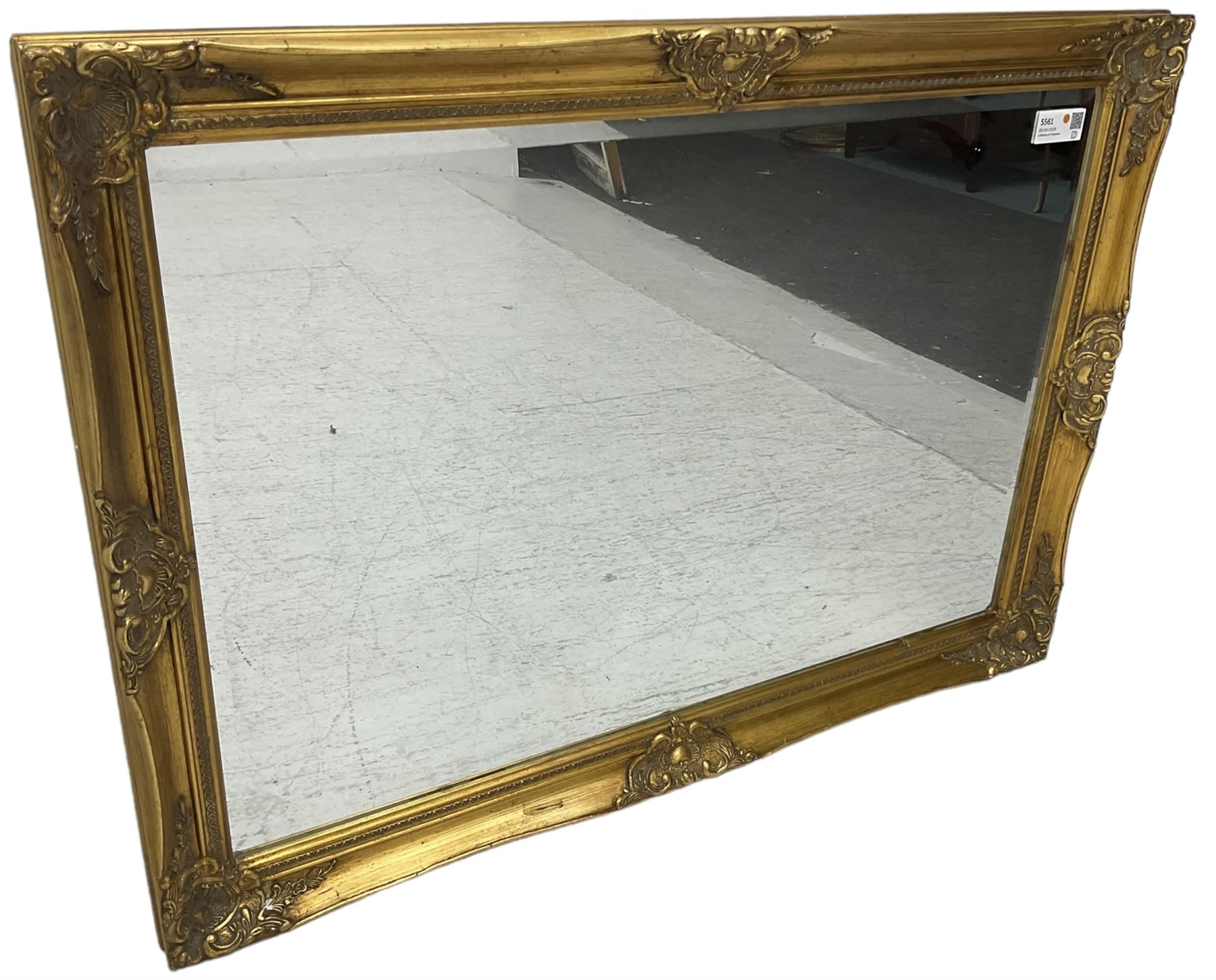 Swept gilt framed wall mirror with rectangular bevelled plate