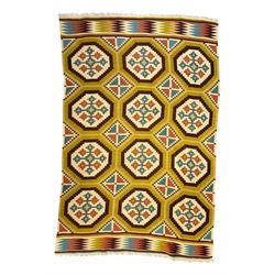 Kilim olive green ground rug, decorated with a repeating pattern of octagonal medallions i...