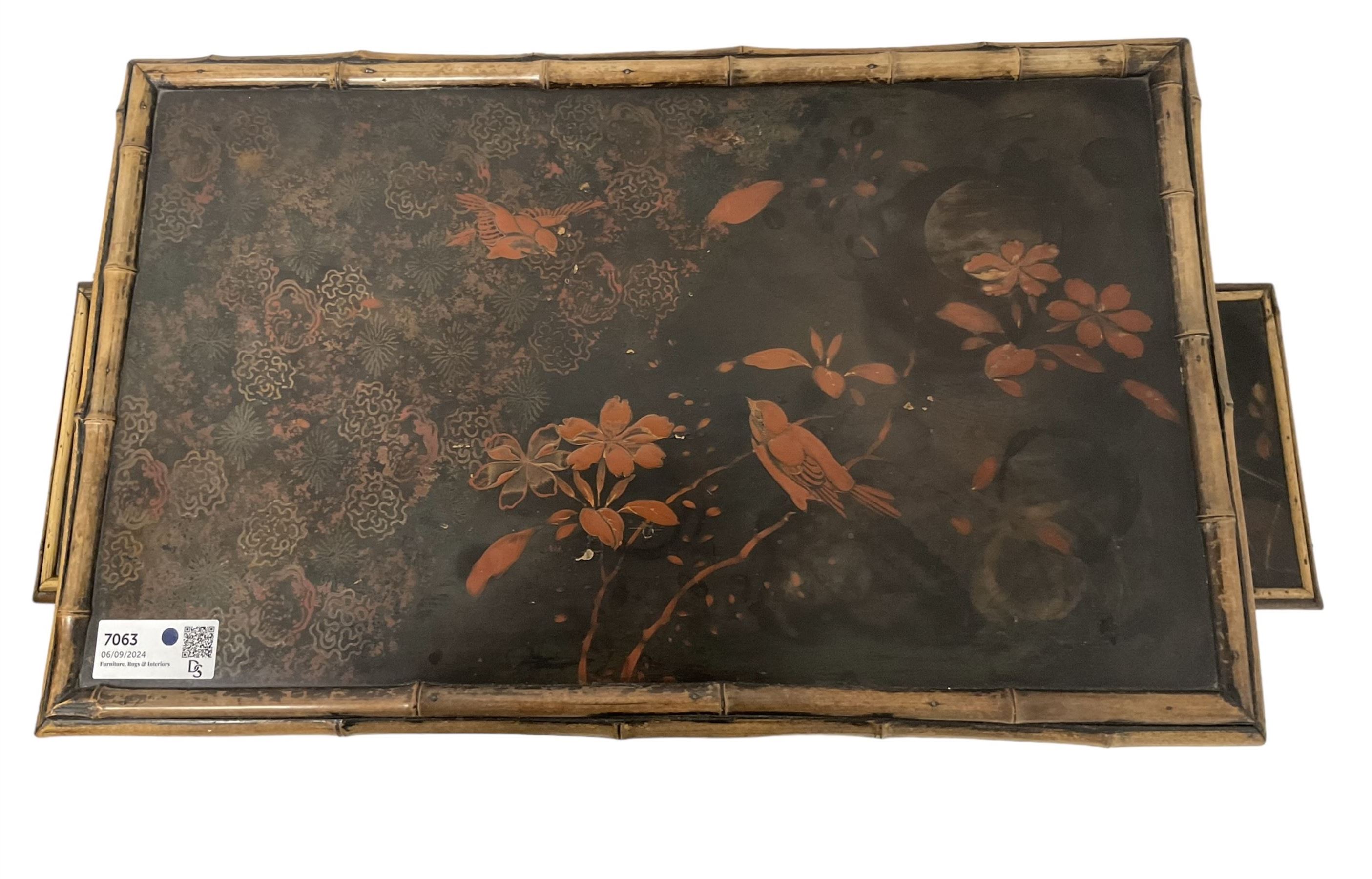 Late 19th century Aesthetic Movement lacquered and painted bamboo occasional table, rectangular top painted with Japanned traditional bird and blossom scenes, over two fold-out side leaves and undertier with pierced gallery apron