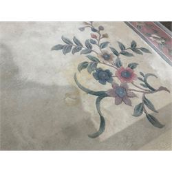 Chinese ivory ground washed woollen carpet, the field decorated with five large floral motifs with extending leafage, the wide rose guard band decorated with further floral patterns