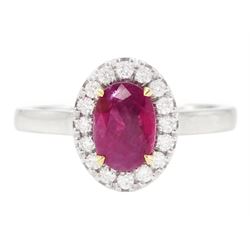 18ct white gold oval cut ruby and round brilliant cut diamond cluster ring, hallmarked, ruby approx 0.85 carat, total diamond weight approx 0.15 carat