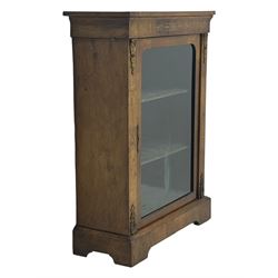 Late Victorian walnut pier cabinet, projecting cornice over frieze inlaid with foliate motifs, single glazed door flanked by ormolu mounts, enclosing shelved interior, on plinth base