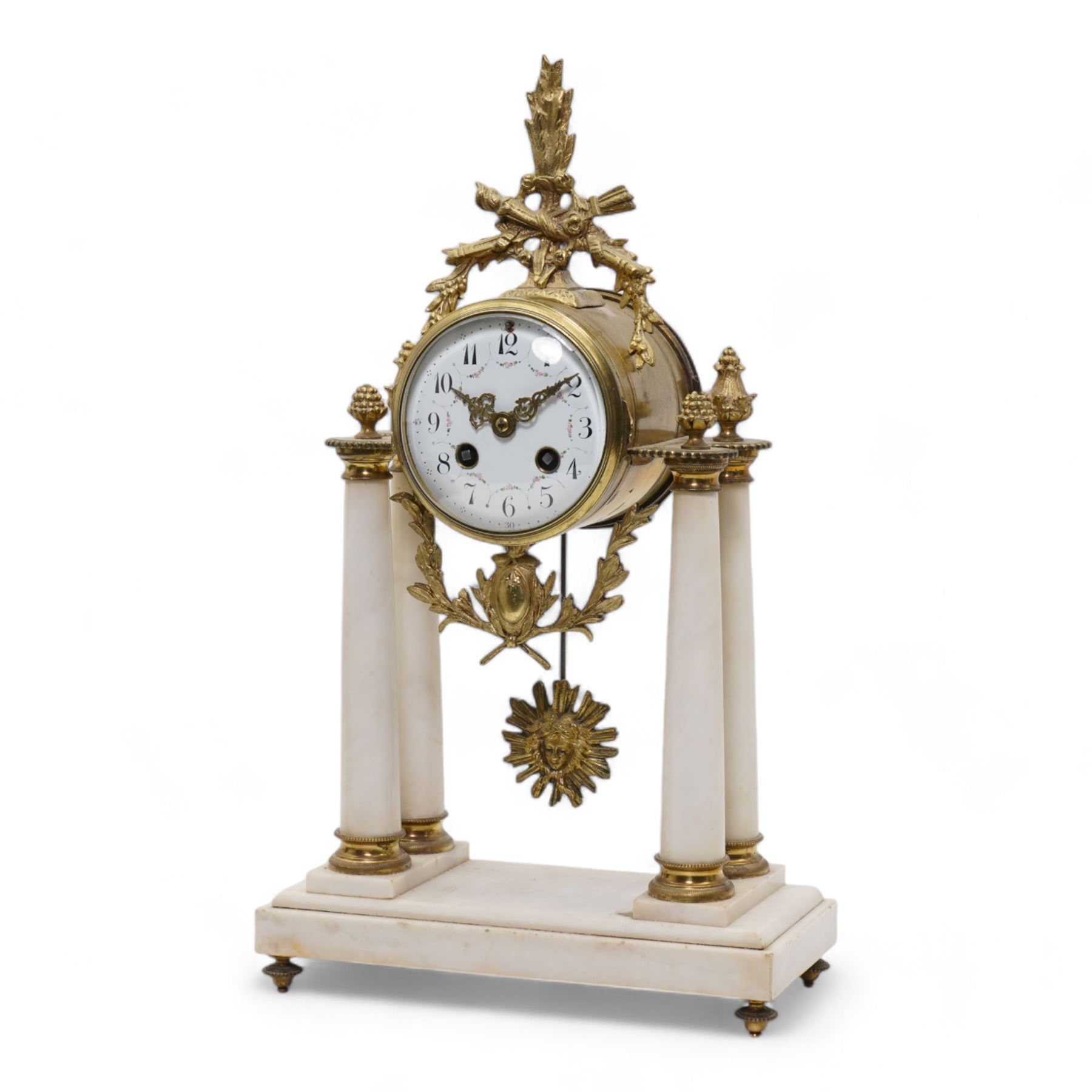 French - White marble and gilt 8-day mantel clock c1900,  with a rectangular plinth raised on four feet, gilt drum movement supported on four tapered pillars with gilt torus base and pineapple finials, convex enamel dial with floral swags and Arabic numerals, minute markers and gilt Louis XV hands, twin train Parisian countwheel striking movement, striking the hours and half-hours on a bell. With a sunburst pendulum.