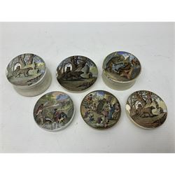 Six 19th century Prattware pot lids comprising 'The Village Wakes', three 'Bear on Rock', 'Shooting Bears' and 'Bear, Lion and Cock', two with associated bases, largest D9cm (6)