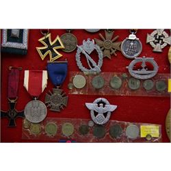 European and World medals and replicas, Italian Commemorative Cross of the 11th Army, German Cross of Honor, Pakistan 1948 general service medal, Belgium Commemorative medal, together with German coins, badges etc, all within a framed display, H29cm, W38cm 