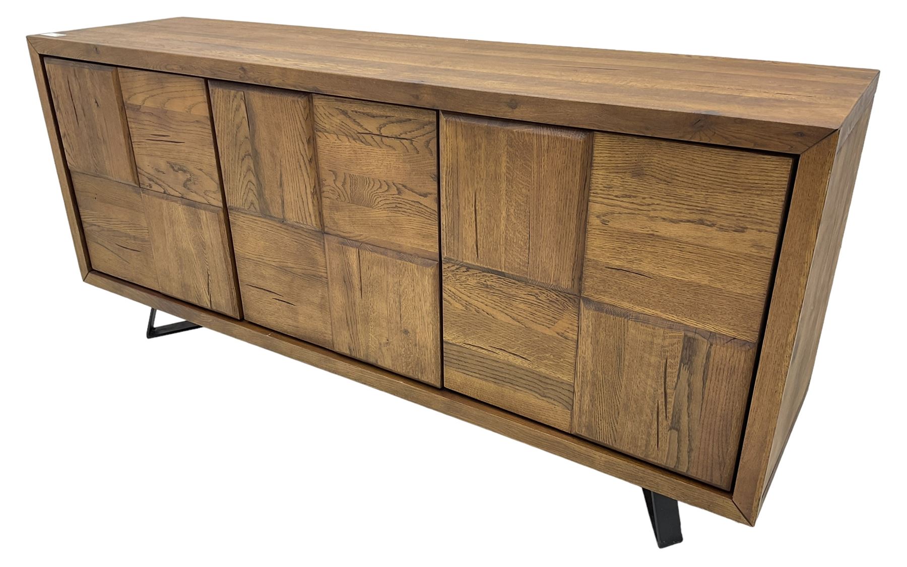 Samba 'Camden' oak sideboard, rectangular top over three block panelled cupboard doors, raised on angled black metal supports connected with stretcher