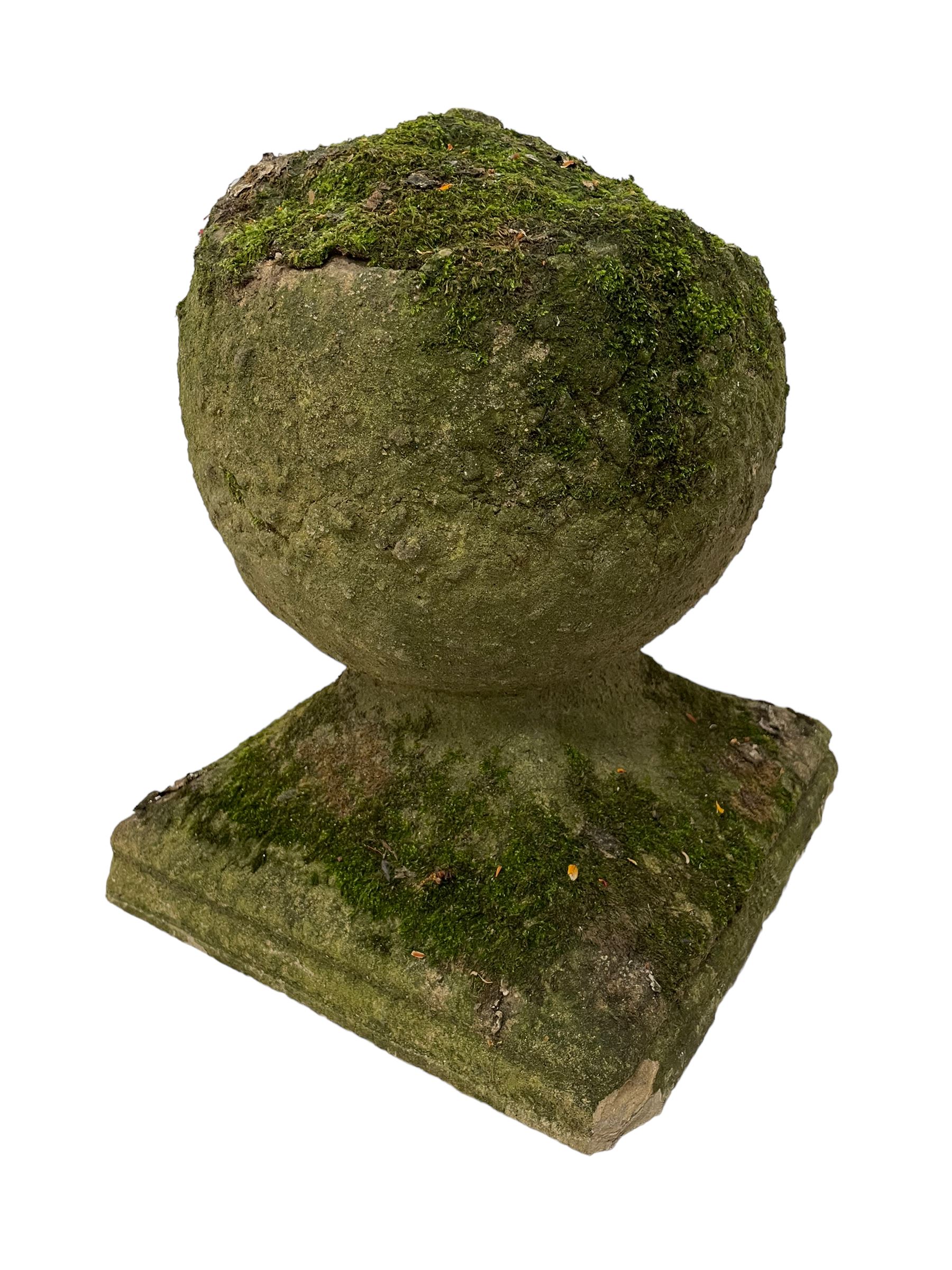 Set of three weathered cast stone gate post finials, circular orb on step-canted square base 