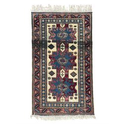 Turkish camel ground rug, three medallions surrounded by geometric motifs, the border deco...