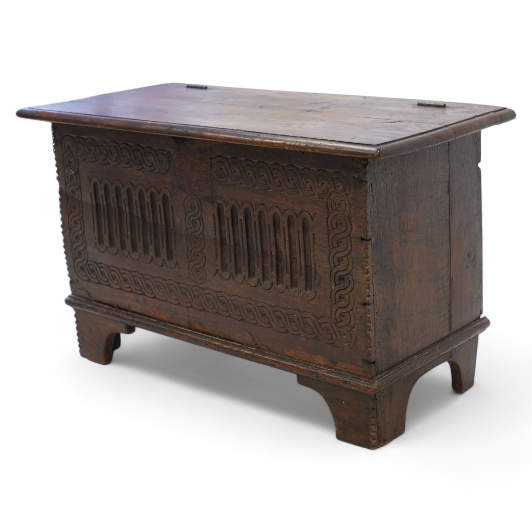 18th century and later plank kist, rectangular form, moulded hinged lid over guilloche and fluted front with chip carved edge, on bracket feet 