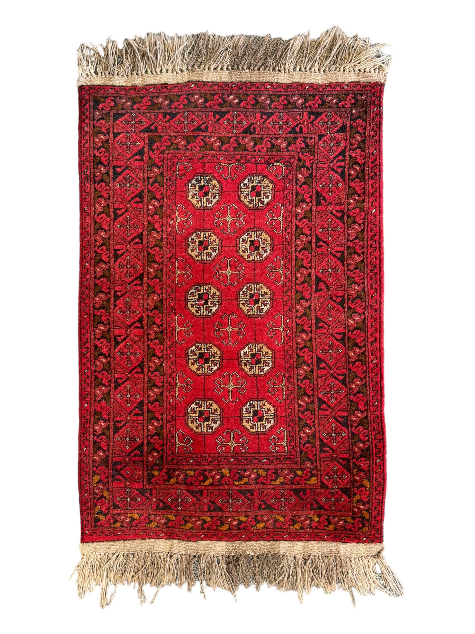 Afghan red ground Bokhara rug, decorated with four central Gul motifs, enclosed by wide geometric guard bands (191cm x 104cm); together with another similar (120cm x 79cm)