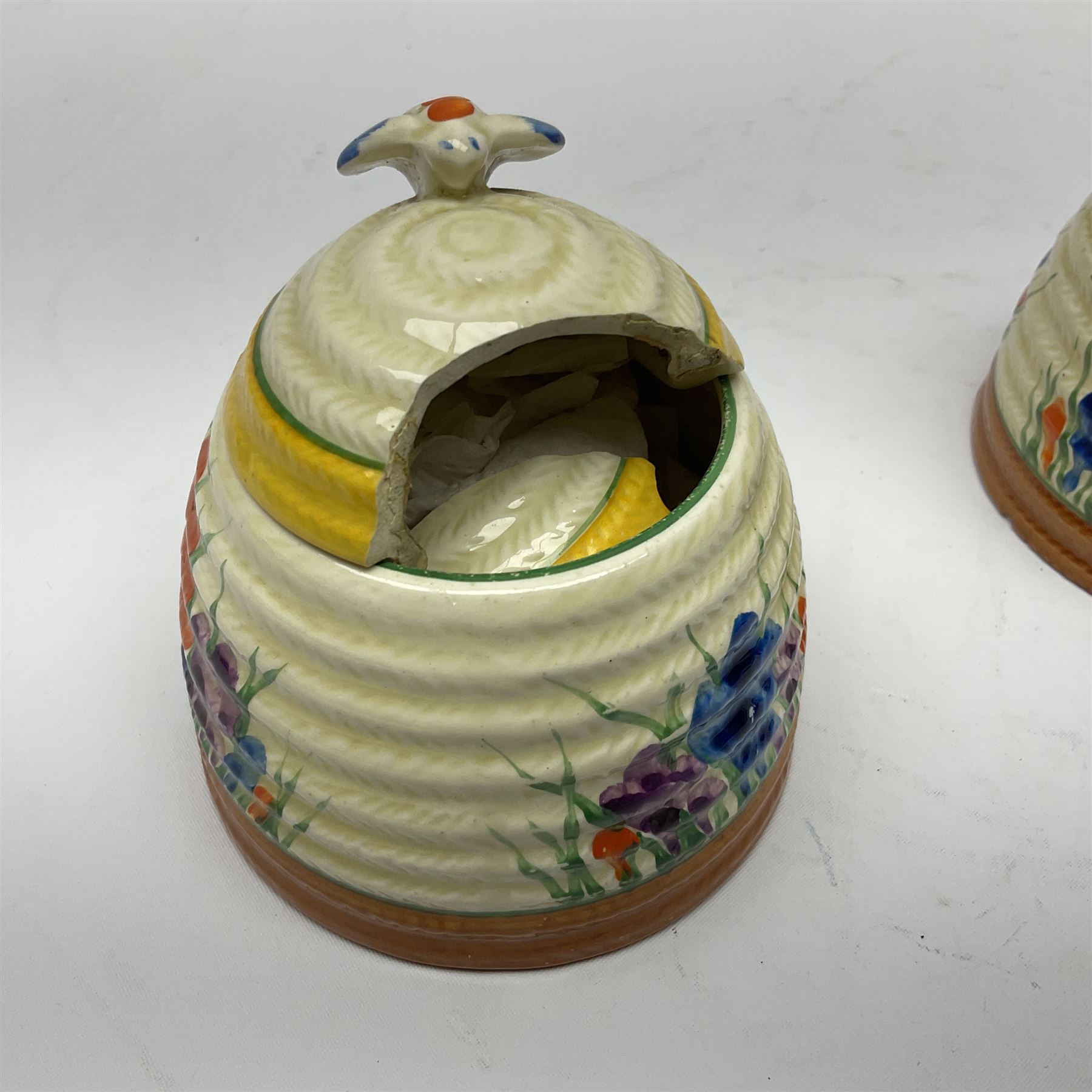 Two Clarice Cliff Bizarre for Newport Pottery, beehive honey pot with cover in Crocus pattern, with printed mark beneath, H9cm