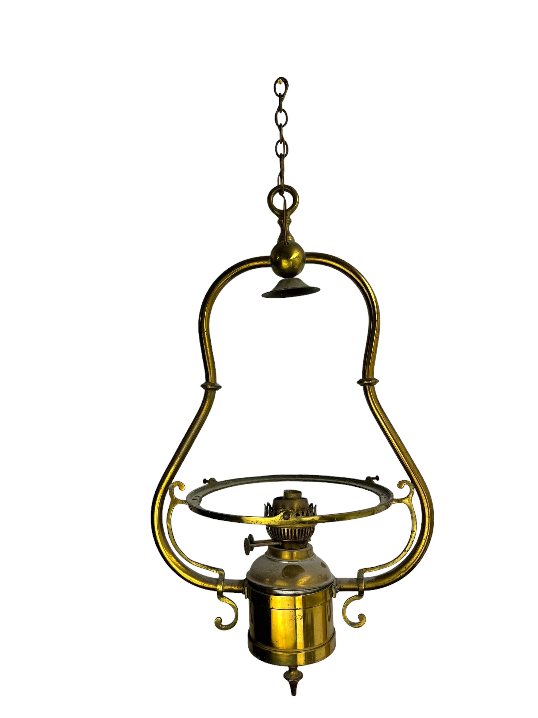 Set three brass framed light fittings, one with white glass shade, converted to electricity, H64cm