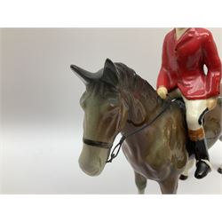 Beswick Hunting Group, comprising: two huntswoman on grey horses, model no 1730, huntsman on a bay horse, model no 1501, a seated fox, model no 1748, eighteen fox hounds and a spaniel, model no 967, all with printed marks beneath, together with three other ceramic huntsman on horseback and two hounds. 