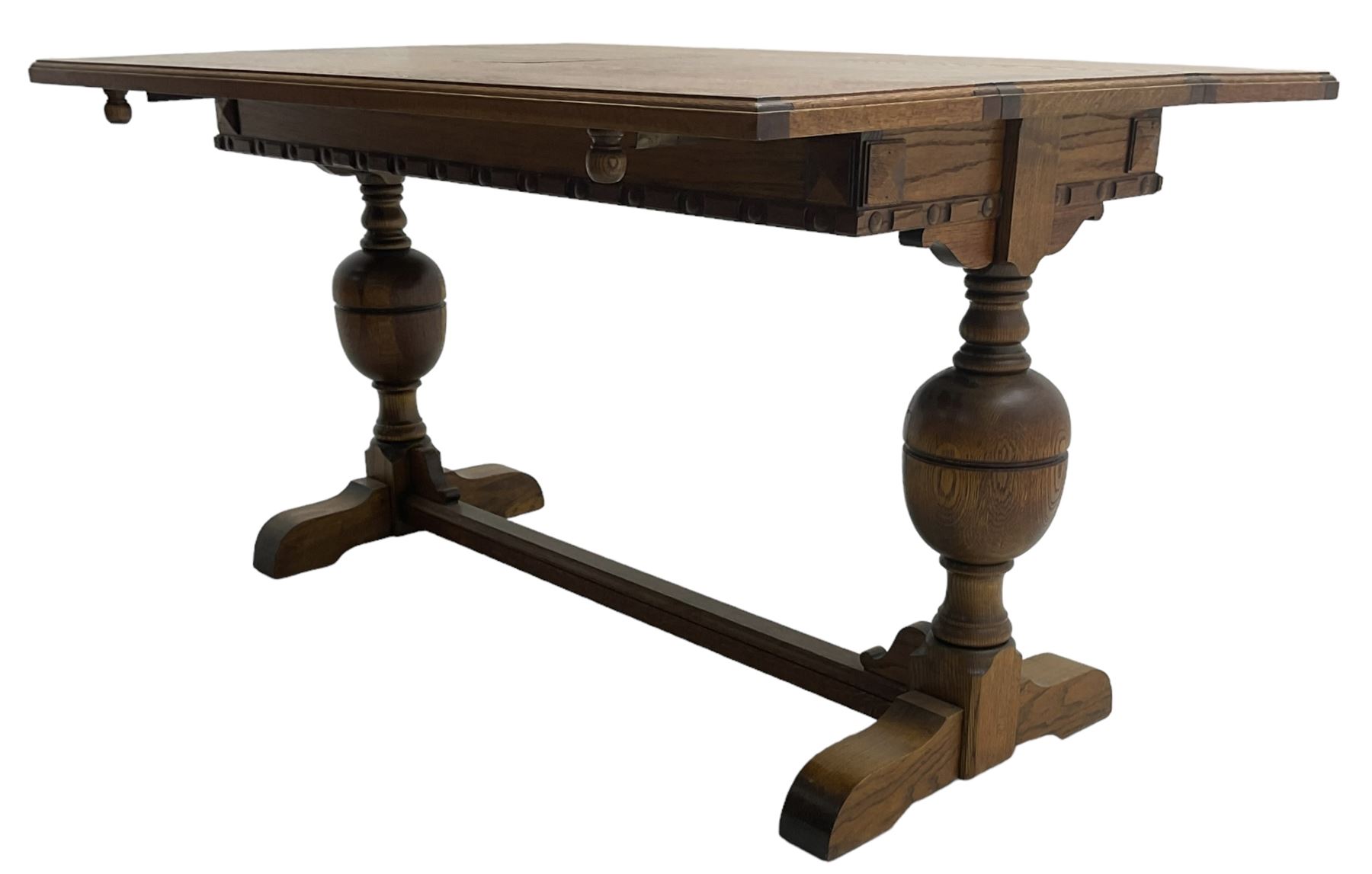 Early 20th century oak 'Ee-zi-Way one motion extending dining table', rectangular top over twin baluster end supports united by stretcher