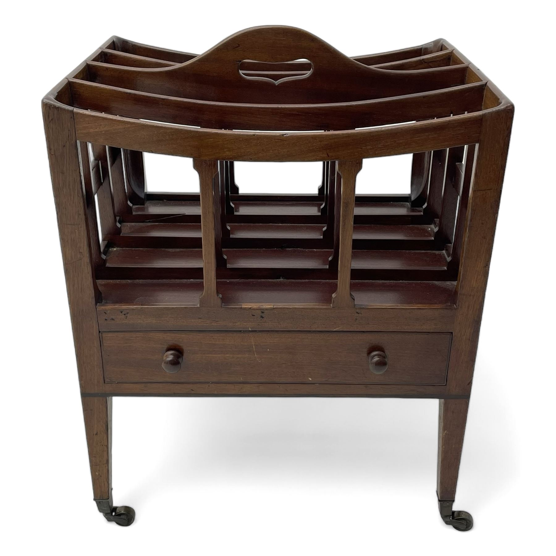 George III mahogany Canterbury, four divisions, fitted with single drawer with turned handles, on square tapering supports with brass cups and castors 