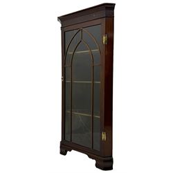 19th century mahogany floor-standing corner display cabinet, moulded cornice over blind fretwork frieze, enclosed by single astragal glazed door, the interior fitted with three shelves, on bracket feet