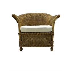 Rattan armchair and ottoman set, pair of armchairs featuring rounded backrests with wide armrests, woven wicker frame with weaving and upholstered seat cushions in off-white fabric with flowing floral pattern (W83 D80 H78cm); matching round ottoman with upholstered cushion on square wooden feet (W65 D65 H37cm)