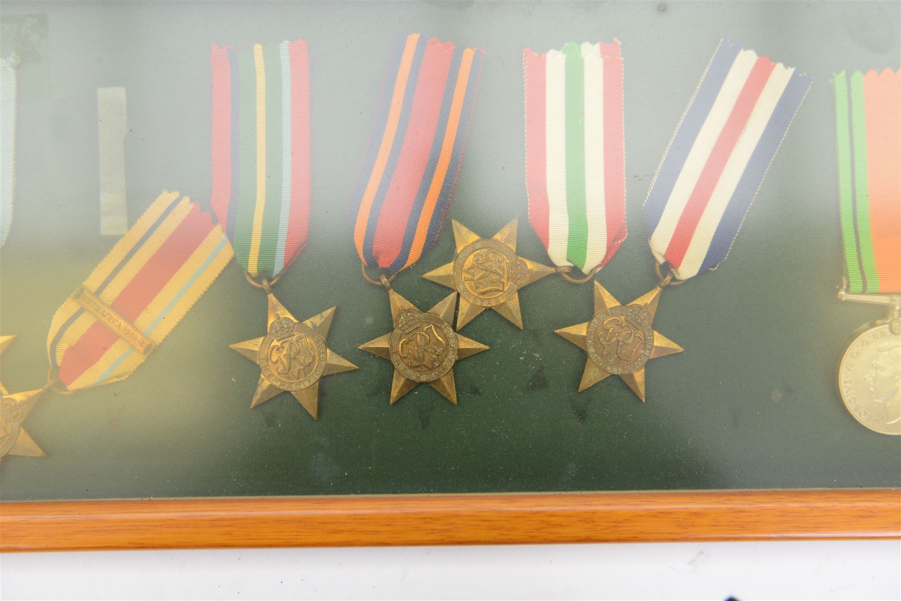 World War II medal group, comprising 1939-45 Star, Pacific Star, Burma Star, Italy Star, 
Atlantic Star, 1939-45 War medal and General Service medal, in glazed frame 