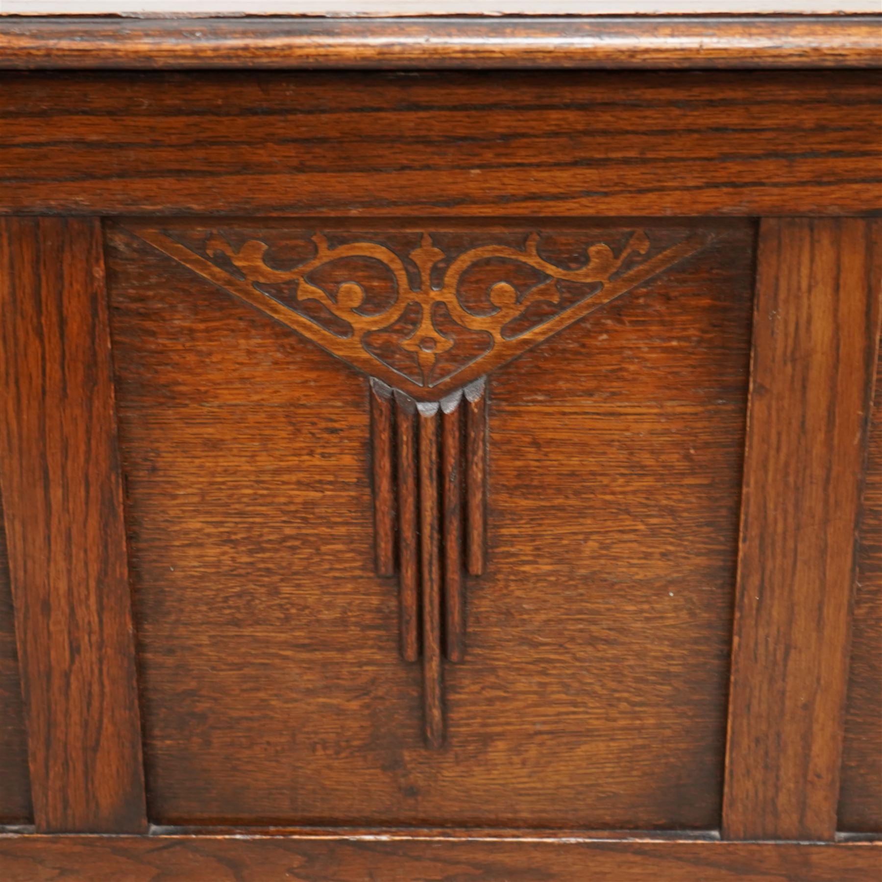 Early 20th century oak blanket chest, rectangular hinged top over triple panelled front with moulded decoration, on foliate carved ogee feet