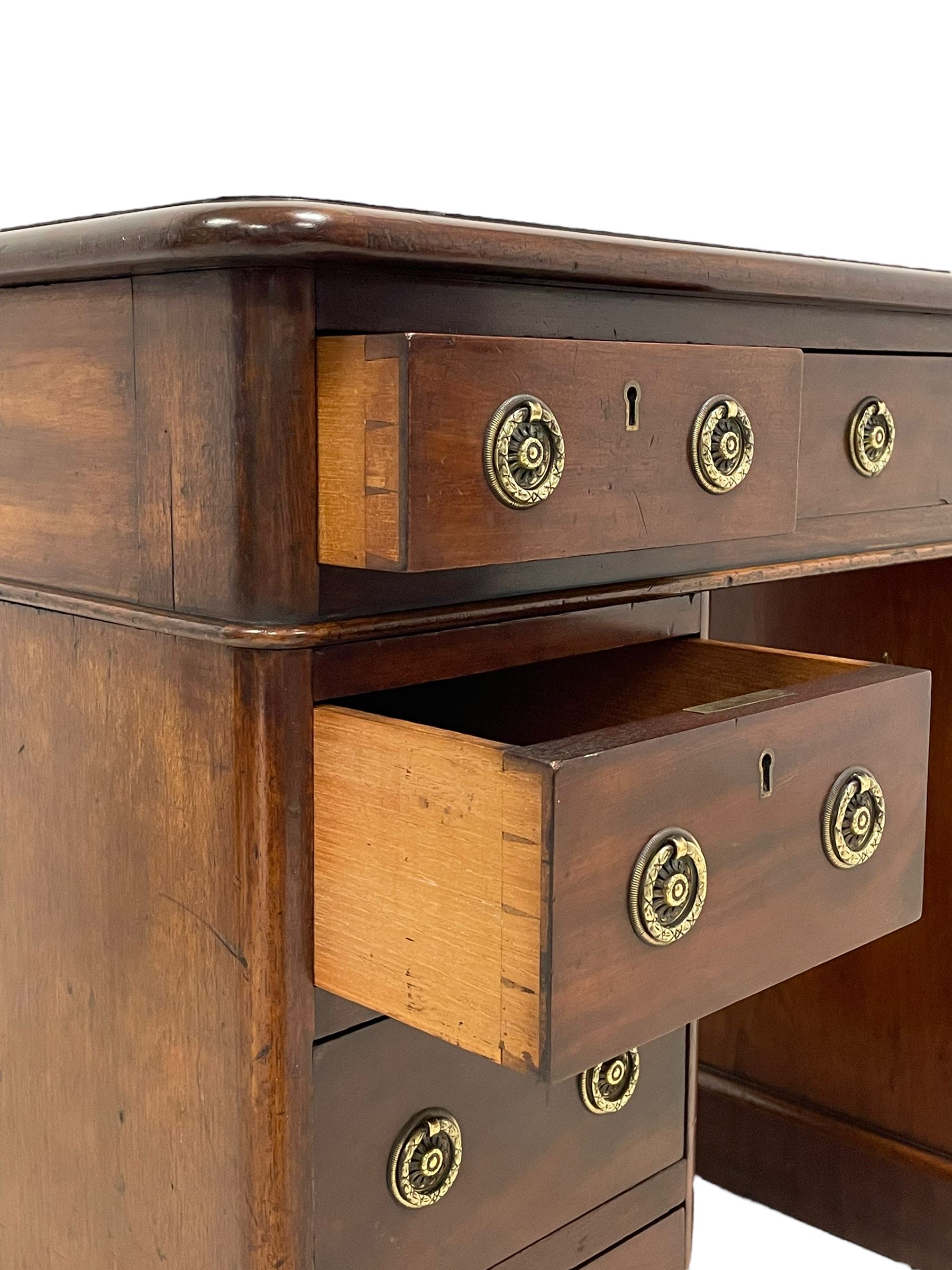 Victorian mahogany twin pedestal desk, moulded rectangular top with rounded corners and inset leather writing surface, fitted with nine drawers, on moulded plinth base