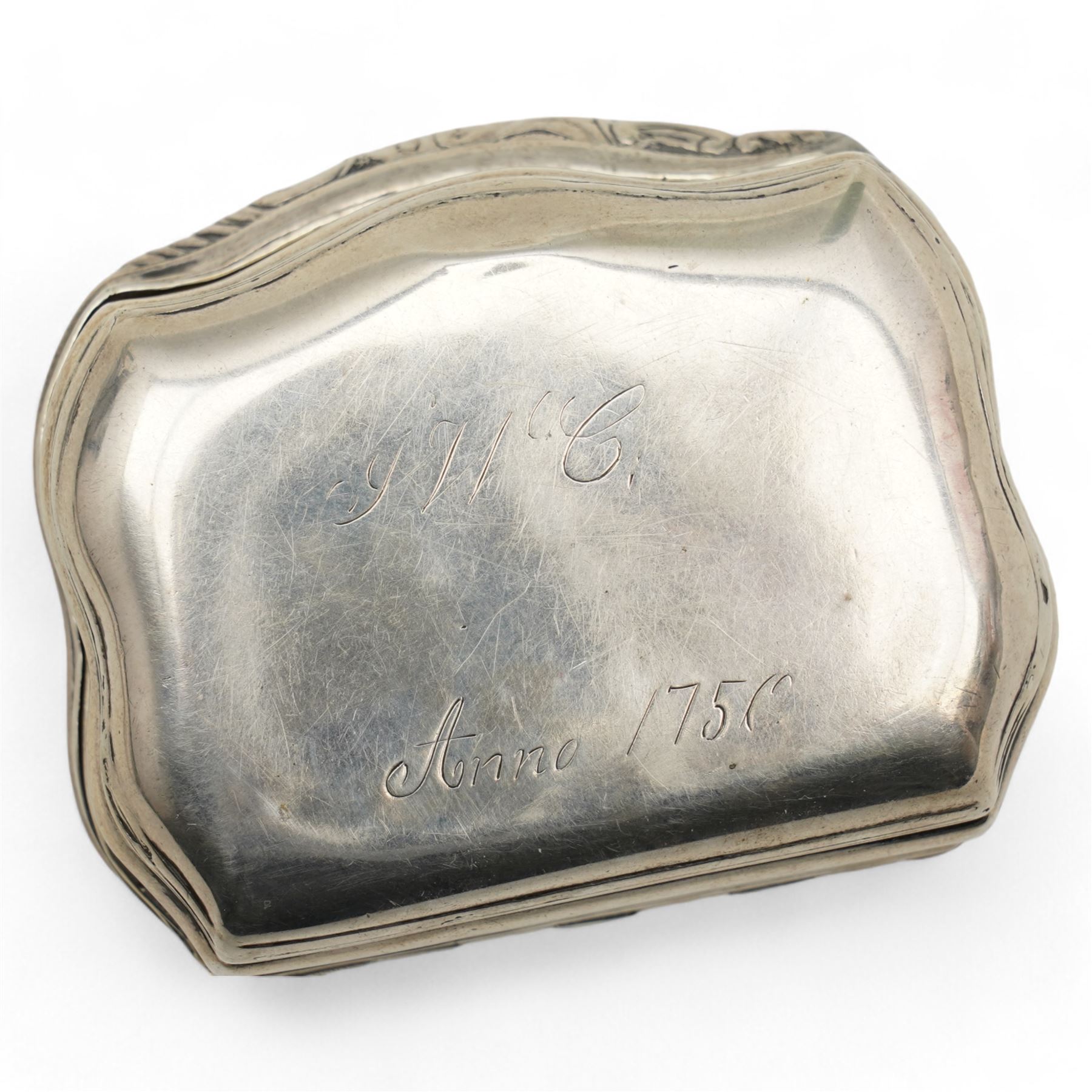 18th century Swedish silver snuff box of serpentine outline, the hinged cover with embossed classical figures, the base engraved 'Anno 1750' and with initials W7cm