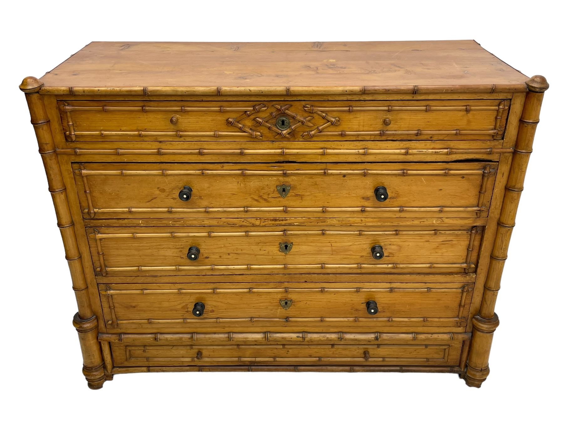 Victorian pine and simulated bamboo chest, fitted with five drawers, the drawer fronts decorated with applied simulated bamboo mounts and turned ebonised handles, on turned front feet