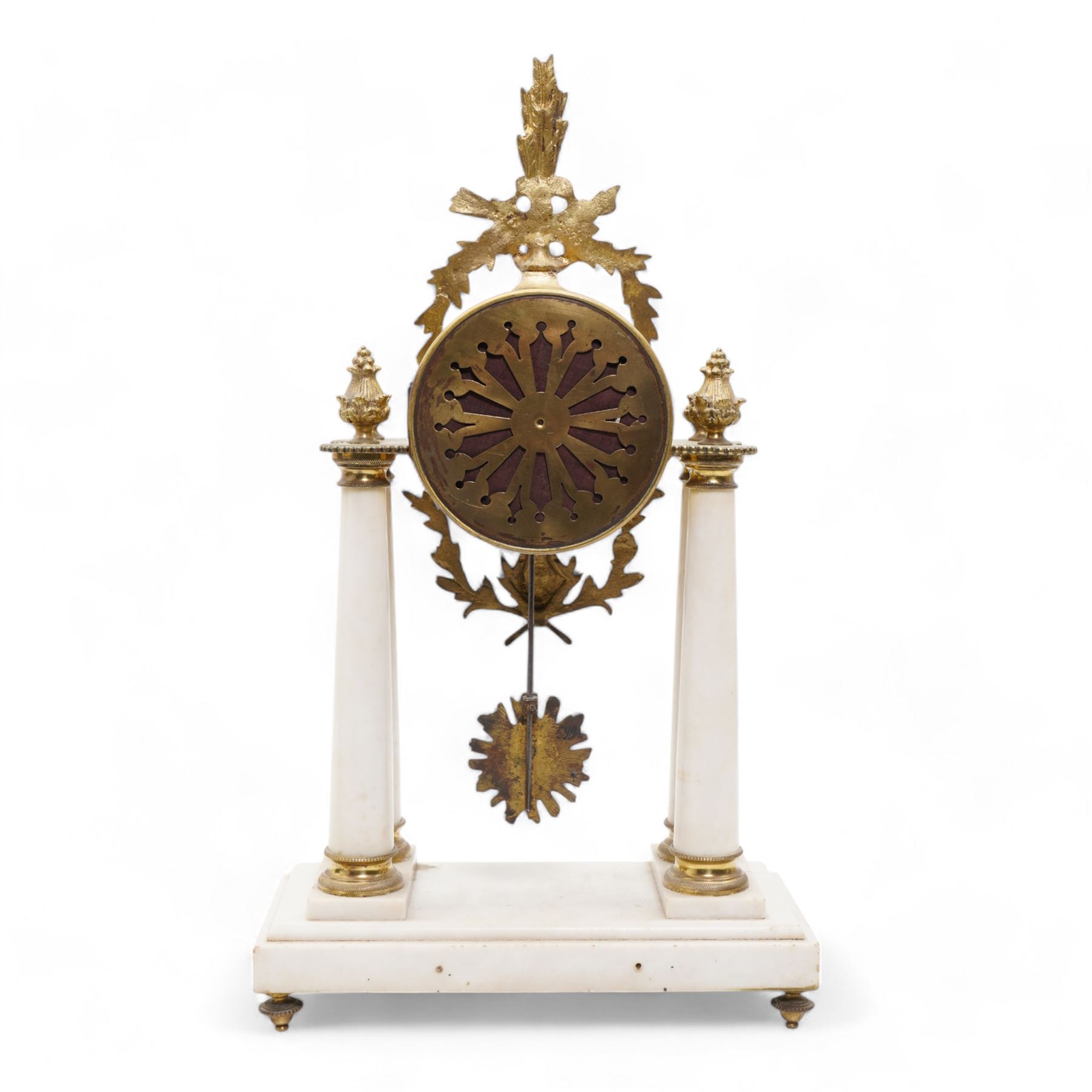 French - White marble and gilt 8-day mantel clock c1900,  with a rectangular plinth raised on four feet, gilt drum movement supported on four tapered pillars with gilt torus base and pineapple finials, convex enamel dial with floral swags and Arabic numerals, minute markers and gilt Louis XV hands, twin train Parisian countwheel striking movement, striking the hours and half-hours on a bell. With a sunburst pendulum.