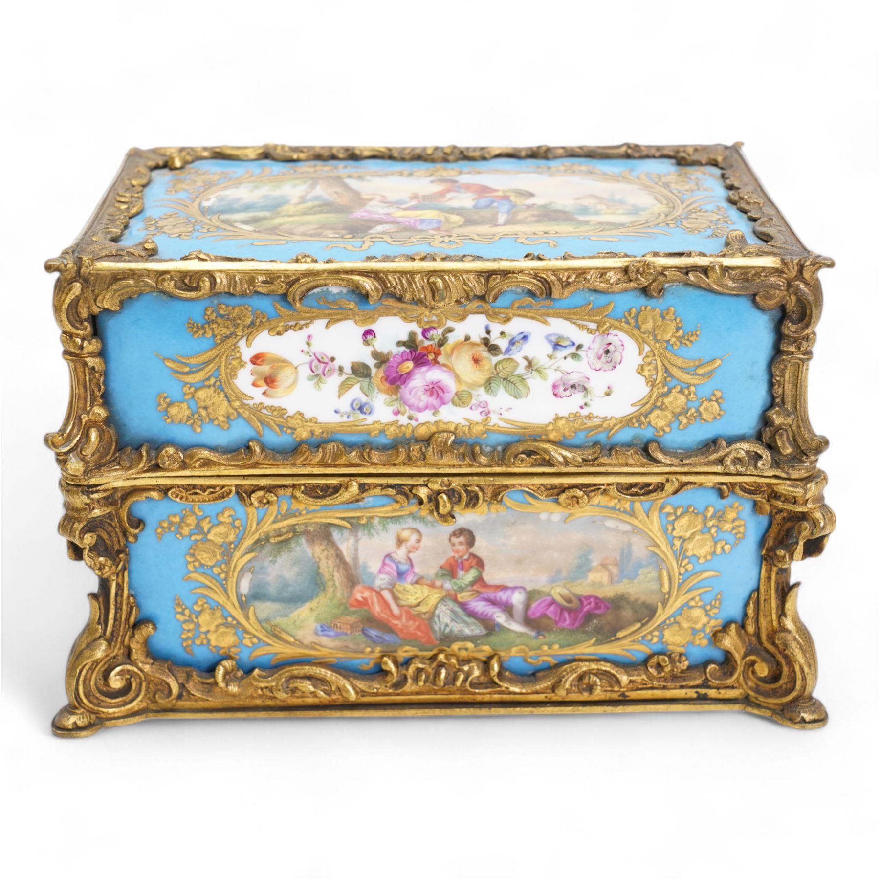 19th century Sevres style porcelain and gilt brass casket, the fall front hinged cover painted with a courting couple in a landscape within raised gilt border on on a bleu celeste ground, the side panels depicting floral sprays and a further courting couple, within gilt brass scroll borders, L20cm x H12.5cm 